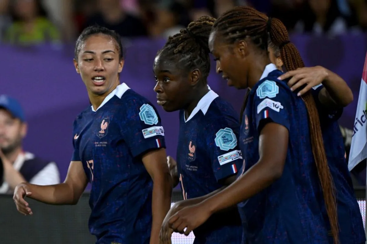 France's midfielder #17 Sandy Baltimorem (C) celebrates with teammates France's midfielder #17 Sandy Baltimore (L) and France's midfielder #08 Grace Geyoro (R) after scoring a goal during the UEFA Women's Euro 2025 Group D football match between France and England at the Letzigrund Stadium in Zurich, on July 5, 2025. Miguel MEDINA / AFP