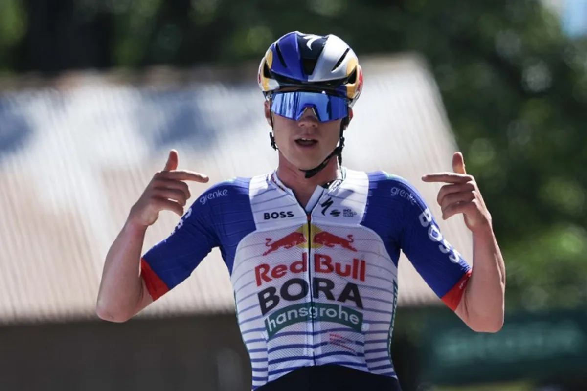 Red Bull - Bora - Hansgrohe's Belgian rider Maxim Van Gils celebrates as he cycles across the finish line to win the 6th stage of the Tour Auvergne-Rhone-Alpes cycling race (formerly known as the Criterium du Dauphine), 182,3km between Saint-Vulbas and Crest-Voland in the French Alps on June 12, 2026. Anne-Christine POUJOULAT / AFP