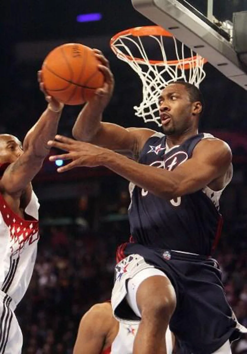 The East's Gilbert Arenas (R) clashes with the West's Kobe Bryant (L) under the basket during the NBA All Star Game, 18 February 2007, in Las Vegas, Nevada. The West's Kobe Bryant of the LA Lakers scored 12 of his 31 points in the fourth quarter as the West came away with a 153-132 win, snapping a two-game losing streak to the East in the National Basketball Association All-Star Game.     AFP PHOTO / GABRIEL BOUYS