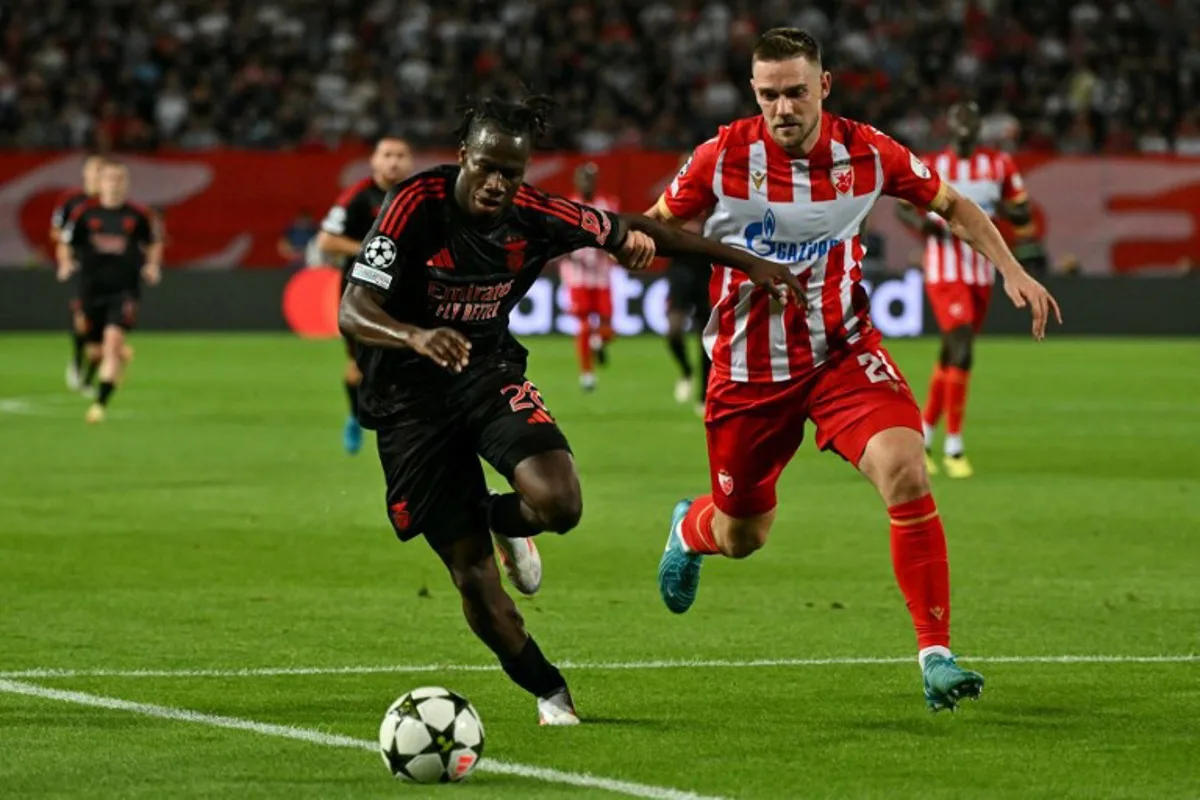 Benfica's Burkinabe defender #28 Issa Kabore (L) and Crvena Zvezda Beograd's Slovenian midfielder #21 Timi Elsnik fight for the ball during the UEFA Champions League 1st round day 1 football match between Crvena Zvezda Beograd and Benfica at the Rajko-Mitic Stadium, in Belgrade, on September 19, 2024.  Andrej ISAKOVIC / AFP