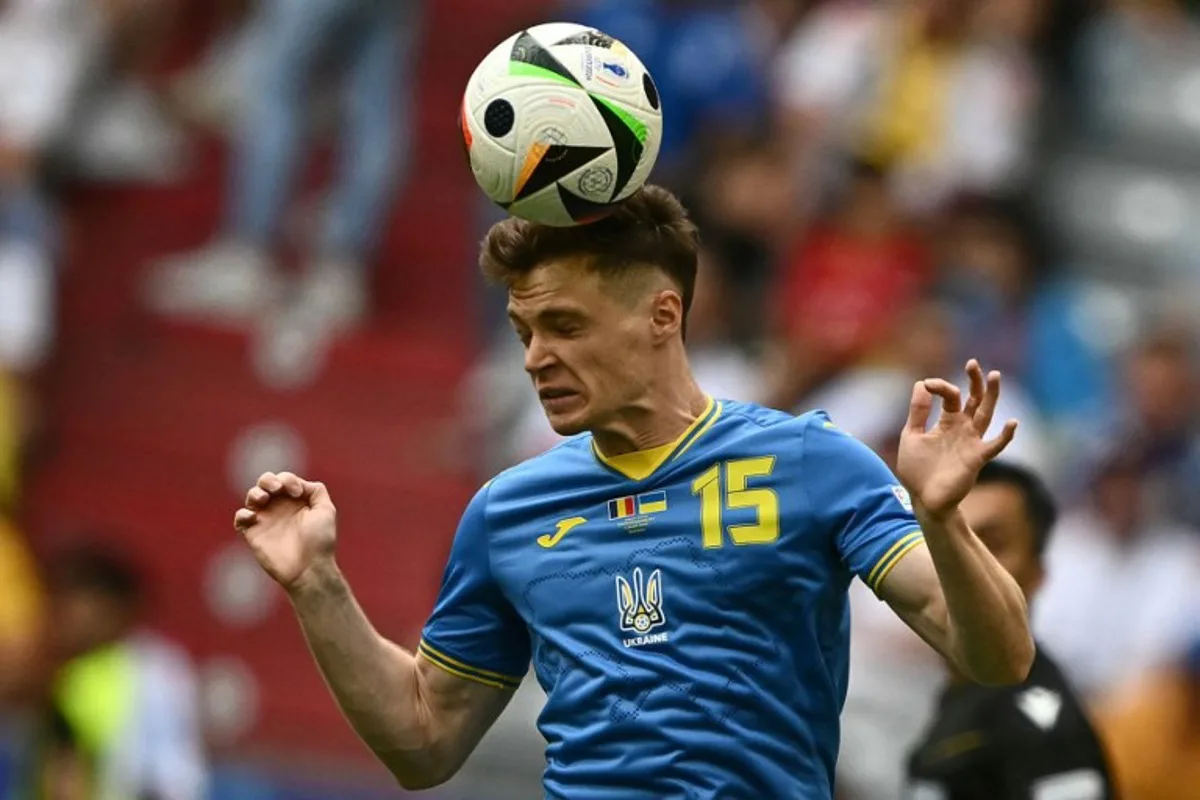 Ukraine's midfielder #15 Viktor Tsygankov heads the ball during the UEFA Euro 2024 Group E football match between Romania and Ukraine at the Munich Football Arena in Munich on June 17, 2024. Fabrice COFFRINI / AFP