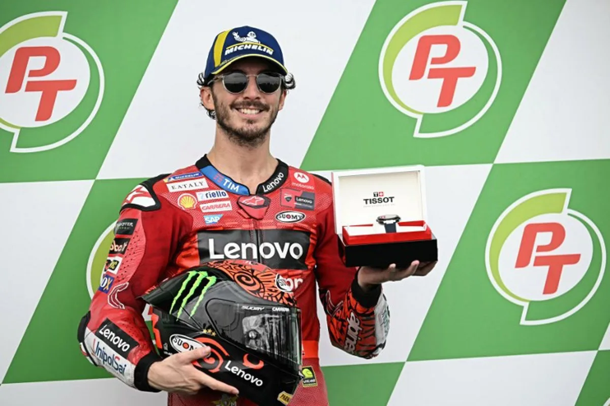 Ducati Lenovo Team's Italian rider Francesco Bagnaia celebrates coming in pole position in the qualifying session of the MotoGP Thailand Grand Prix at the Buriram International Circuit in Buriram on October 26, 2024.  Lillian SUWANRUMPHA / AFP