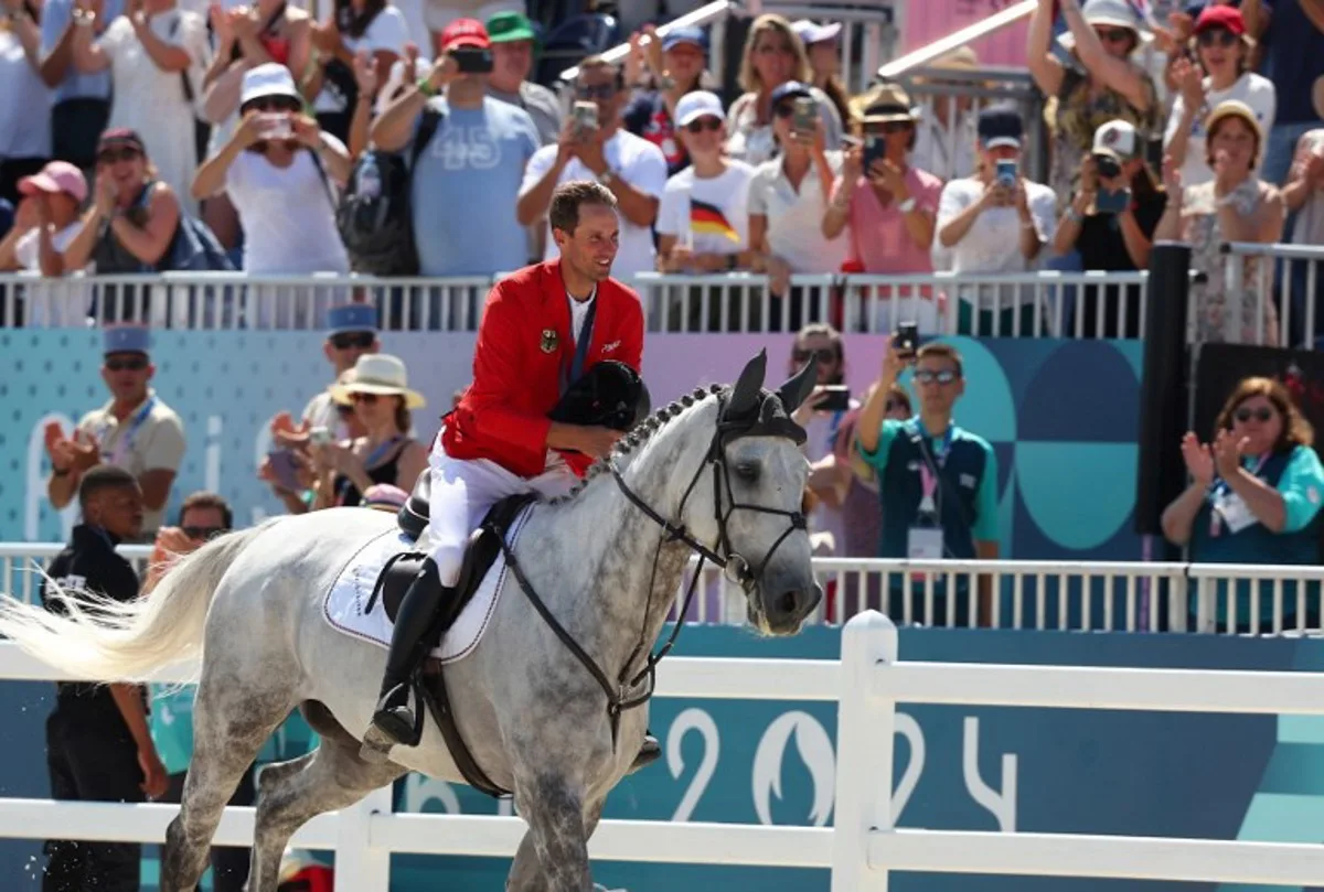 Gold medallist Germany's Christian Kukuk celebrates after the equestrian's jumping individual final during the Paris 2024 Olympic Games at the Chateau de Versailles, in Versailles, in the western outskirts of Paris, on August 6, 2024.  Pierre-Philippe MARCOU / AFP