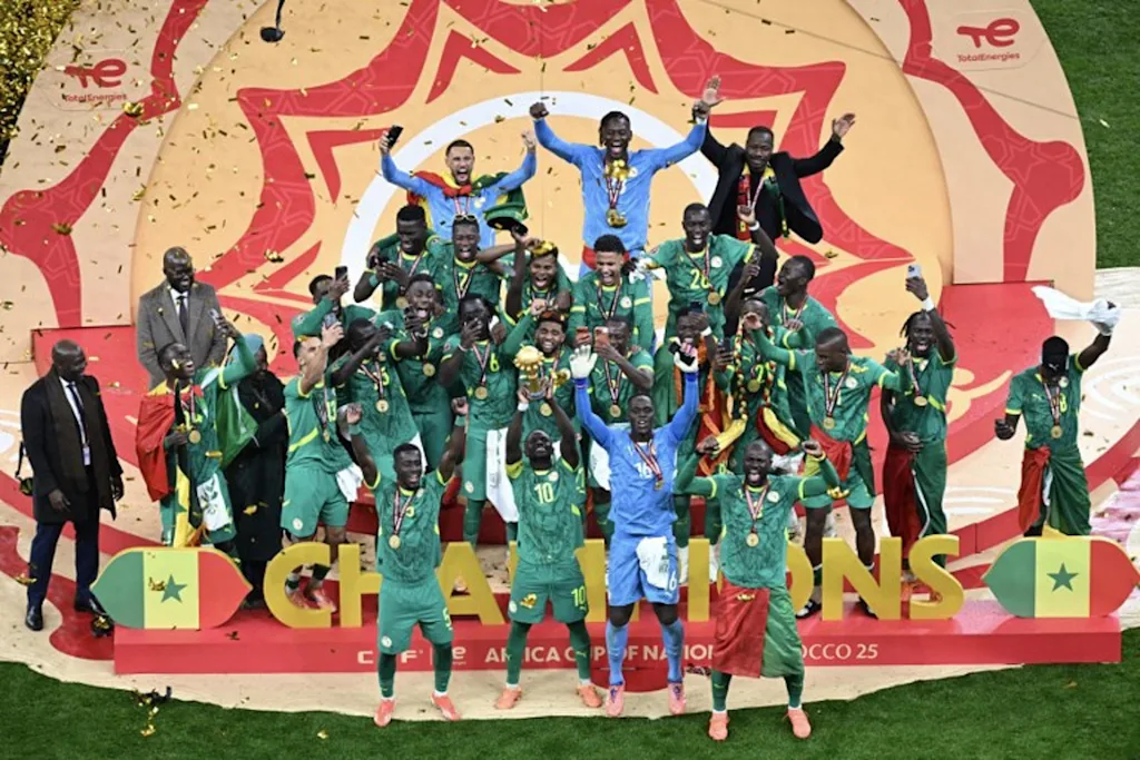 Senegal players celebrate with the trophy after winning the Africa Cup of Nations (CAN) final football match against Morocco at the Prince Moulay Abdellah Stadium in Rabat on January 18, 2026.   Paul ELLIS / AFP
