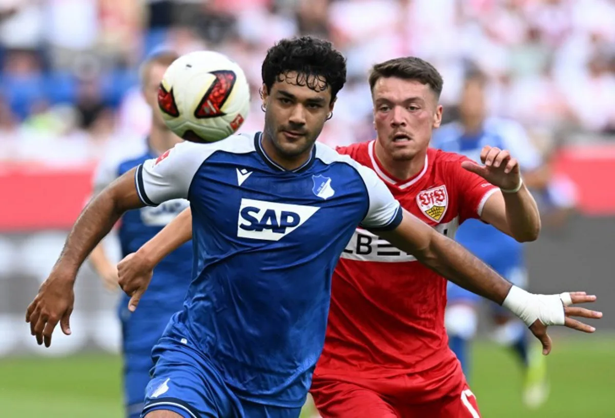 Hoffenheim's Turkish defender #05 Ozan Kabak (L) and Stuttgart's German forward #17 Dzenan Pejcinovic vie for the ball during the German first division Bundesliga football match between Hoffenheim and VfB Stuttgart in Sinsheim on September 12, 2026. THOMAS KIENZLE / AFP