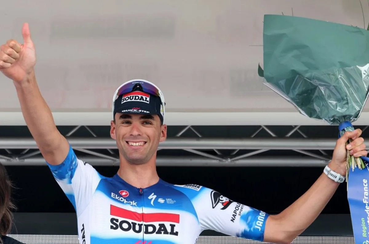 Soudal-Quick Step's Belgian rider Warre Vangheluwe, celebrates on the podium after winning the fourth stage of the "4 jours de Dunkerque" (Four days of Dunkirk) cycling race, 171,3 km from Mazingarbe to Pont-a-Marcq, in north France, on May 17, 2024.  FRANCOIS LO PRESTI / AFP