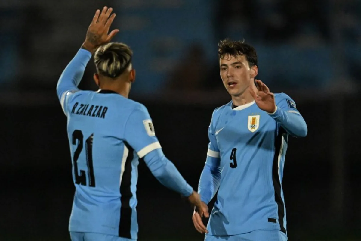 Uruguay's forward #09 Fedrico Vinas celebrates with Uruguay's midfielder #21 Rodrigo Zalazar after scoring his team's third goal during the 2026 FIFA World Cup South American qualifiers football match between Uruguay and Peru at the Centenario stadium in Montevideo on September 4, 2025. Eitan ABRAMOVICH / AFP
