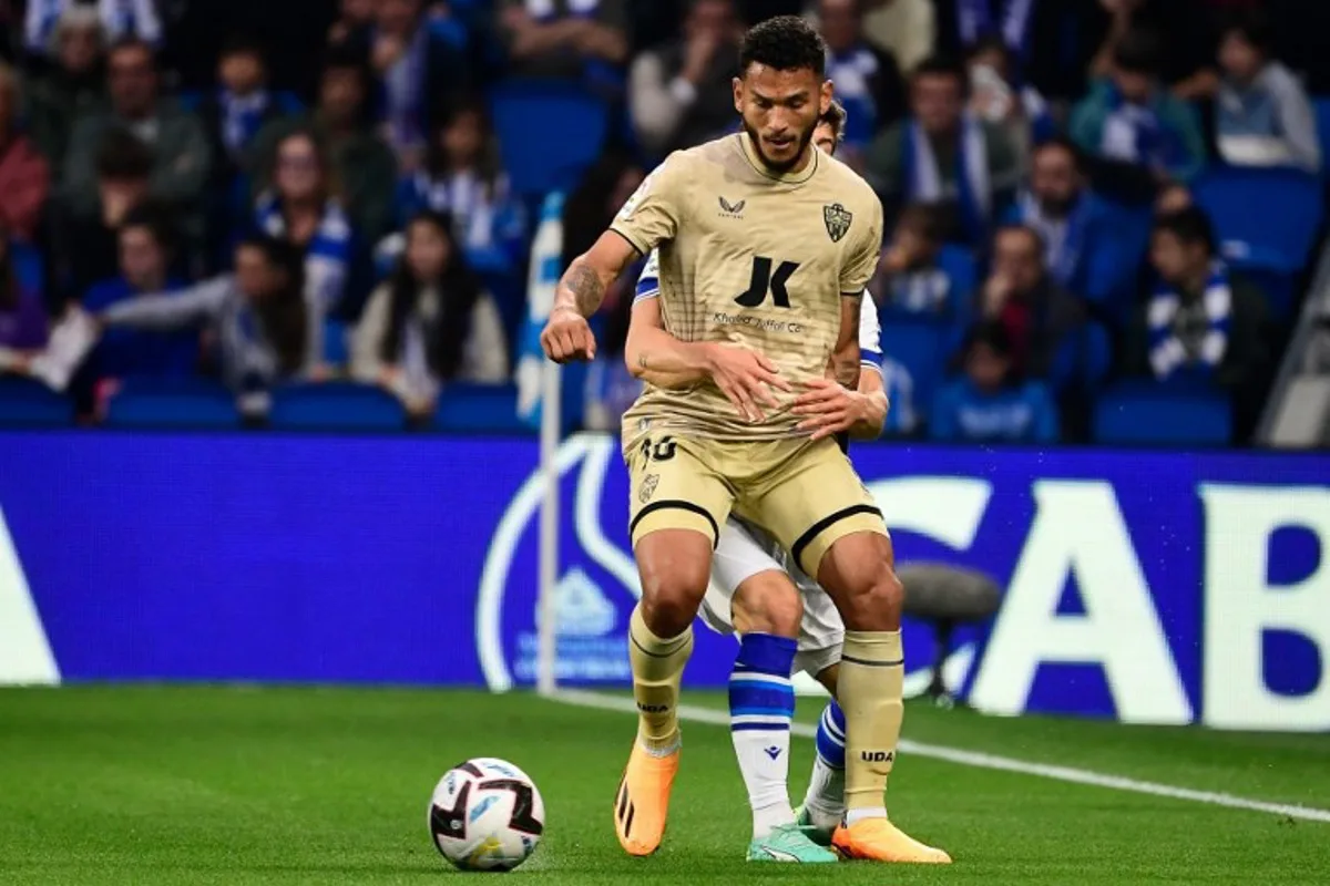 Almeria's Colombian forward Luis Suarez (Front) fights for the ball with Real Sociedad's Spanish defender Aihen Munoz during the Spanish league football match between Real Sociedad and UD Almeria at the Reale Arena stadium in San Sebastian on May 23, 2023. ANDER GILLENEA / AFP