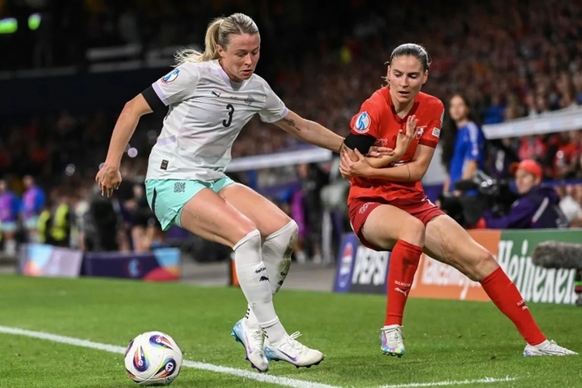 Iceland's forward #03 Sandra Jessen and Switzerland's midfielder #14 Smilla Vallotto fight for the ball during the UEFA Women's Euro 2025 Group A football match between Switzerland and Iceland at the Wankdorf stadium in Bern, on July 6, 2025. SEBASTIEN BOZON / AFP