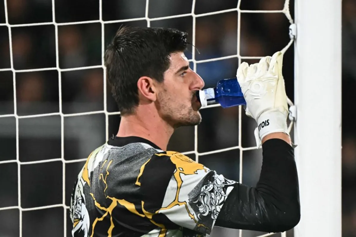 Real Madrid's Belgian goalkeeper #01 Thibaut Courtois drinks during the warming-up prior to the Spanish league football match between Elche CF and Real Madrid CF at Martinez Valero Stadium in Elche on November 23, 2025. JOSE JORDAN / AFP