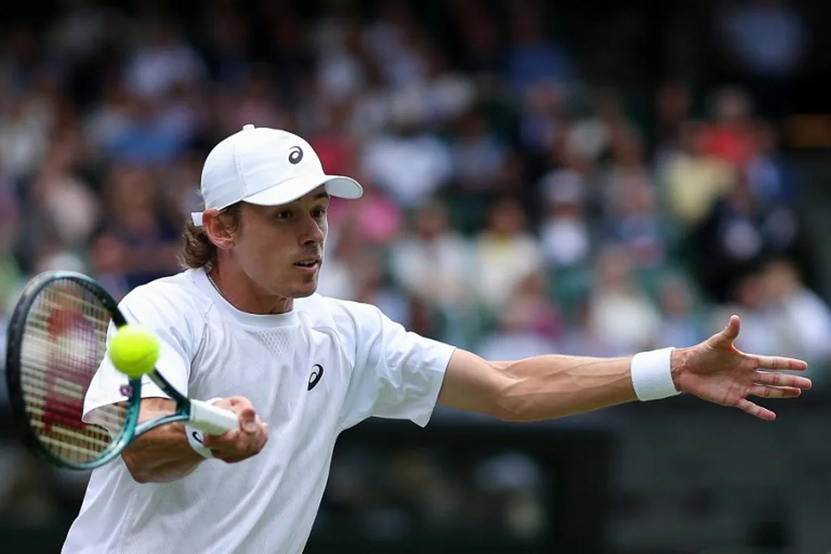 Australia's Alex De Minaur plays a forehand return to Serbia's Novak Djokovic during their men's singles fourth round tennis match on the eighth day of the 2025 Wimbledon Championships at The All England Lawn Tennis and Croquet Club in Wimbledon, southwest London, on July 7, 2025. Adrian Dennis / AFP
