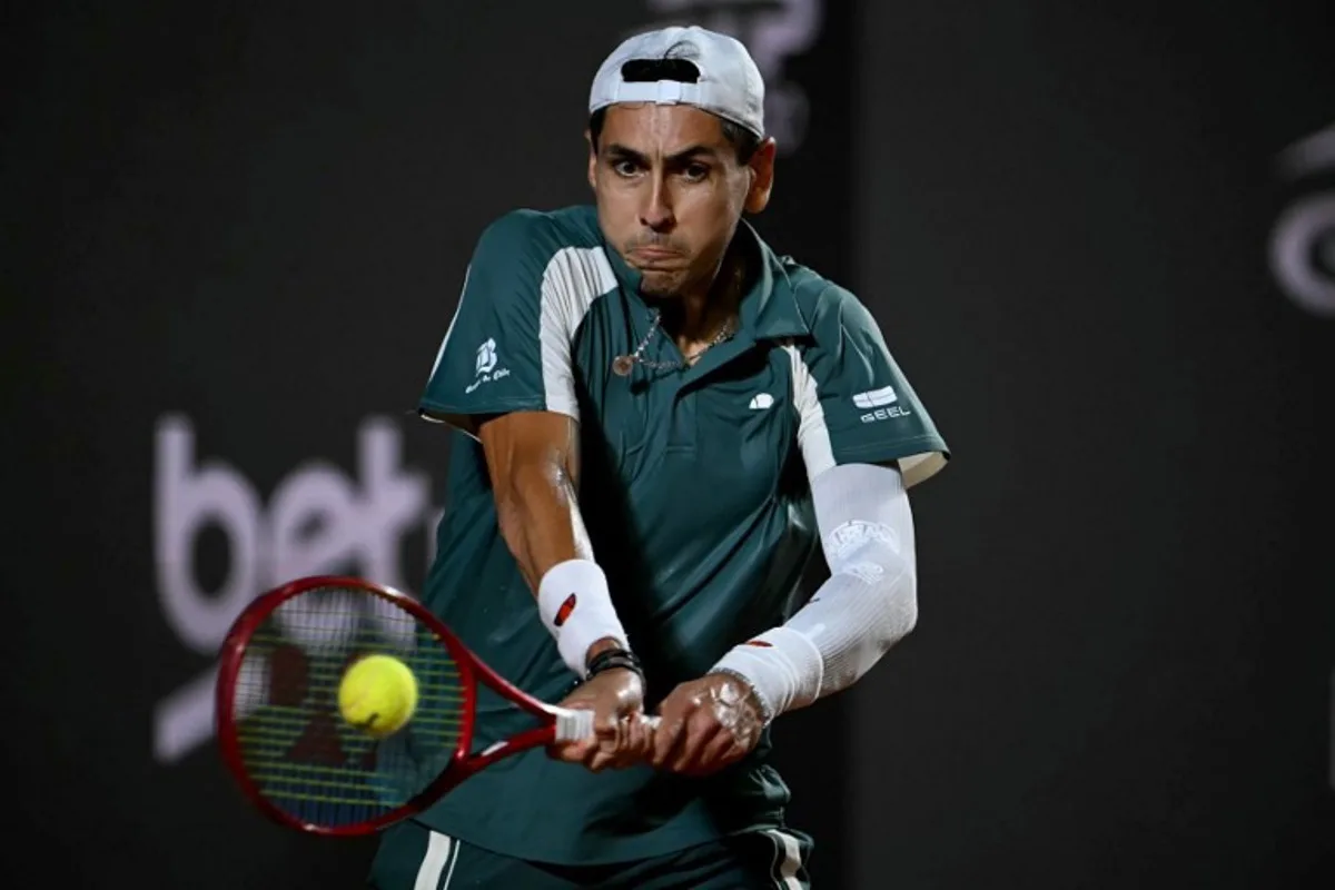 Chile's Alejandro Tabilo hits a return against Argentina's Tomas Etcheverry during their men's singles final match at the Rio Open tennis tournament in Rio de Janeiro, Brazil, on February 22, 2026.  Mauro PIMENTEL / AFP