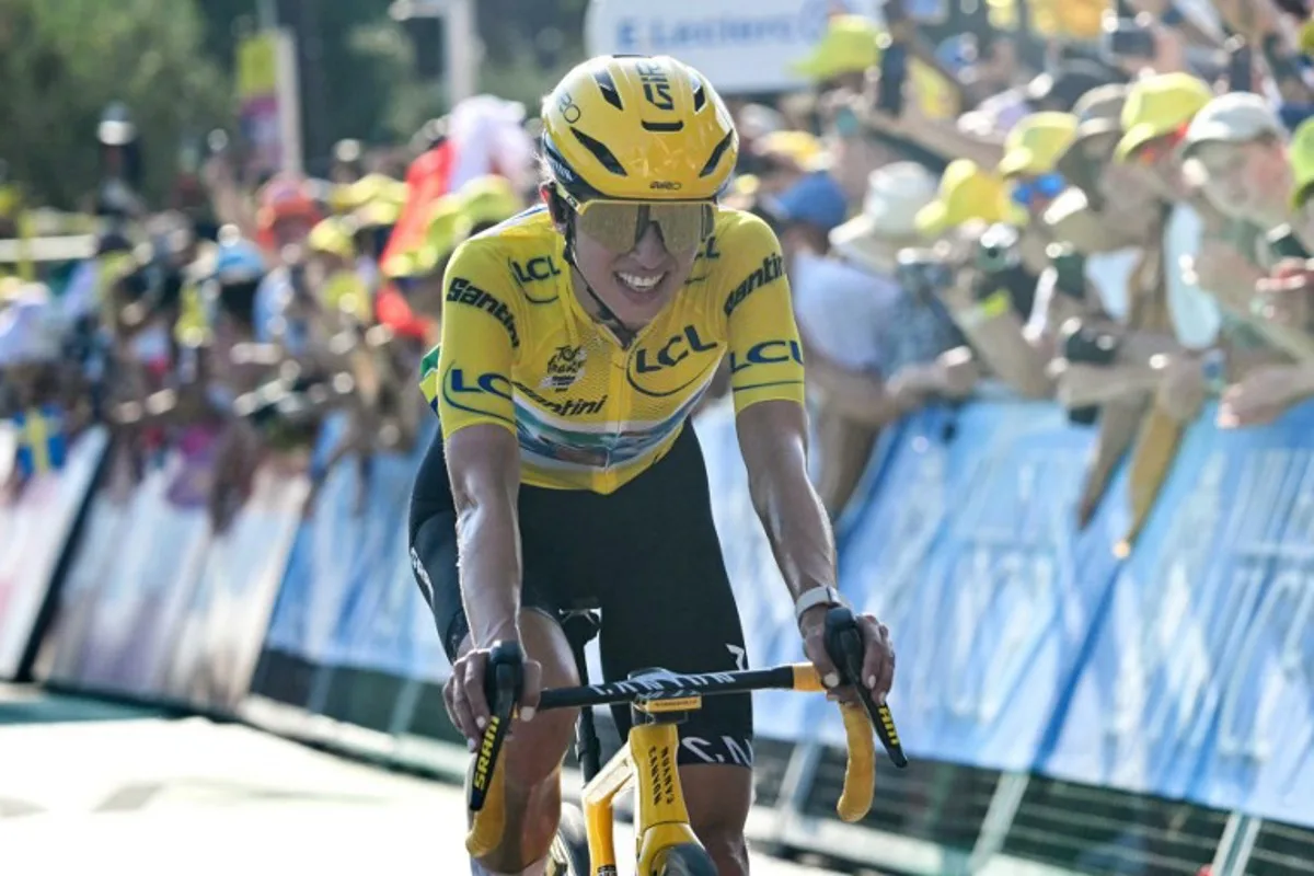 Canyon//SRAM zondacrypto's Polish rider Katarzyna Niewiadoma, wearing the overall leader's yellow jersey, crosses the finish line during the 8th (out of 9) stage of the fifth edition of the Women's Tour de France cycling race, 171.9 km from Sisteron to Nice, in Nice, southeastern France on August 8, 2026. NICOLAS TUCAT / AFP