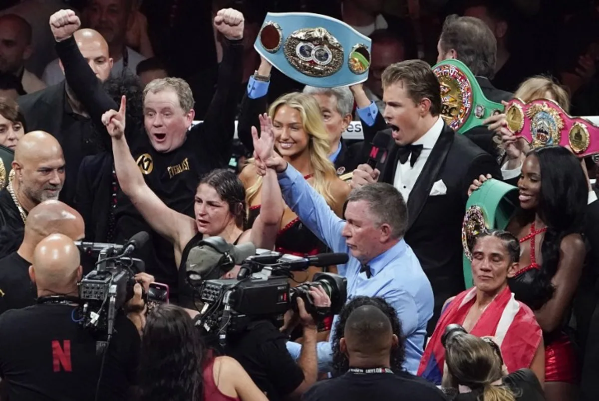 Irish boxer Katie Taylor (L) celebrates keeping the super-lightweight world championship title after fighting Puerto Rican boxer Amanda Serrano (R) at The Pavilion at AT&T Stadium in Arlington, Texas, November 15, 2024.  TIMOTHY A. CLARY / AFP