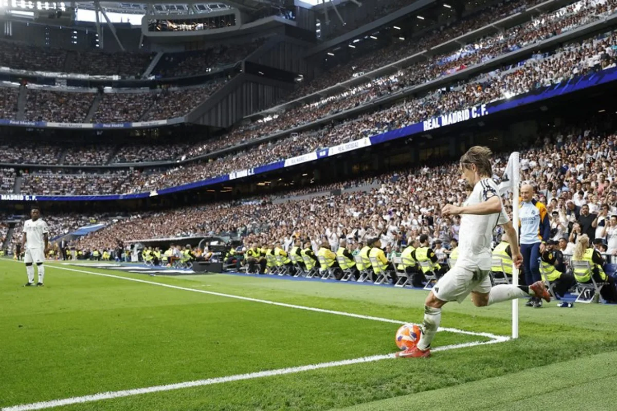 Real Madrid's Croatian midfielder #10 Luka Modric takes a corner during the Spanish league football match between Real Madrid CF and Real Sociedad at Santiago Bernabeu Stadium in Madrid on May 24, 2025. OSCAR DEL POZO / AFP