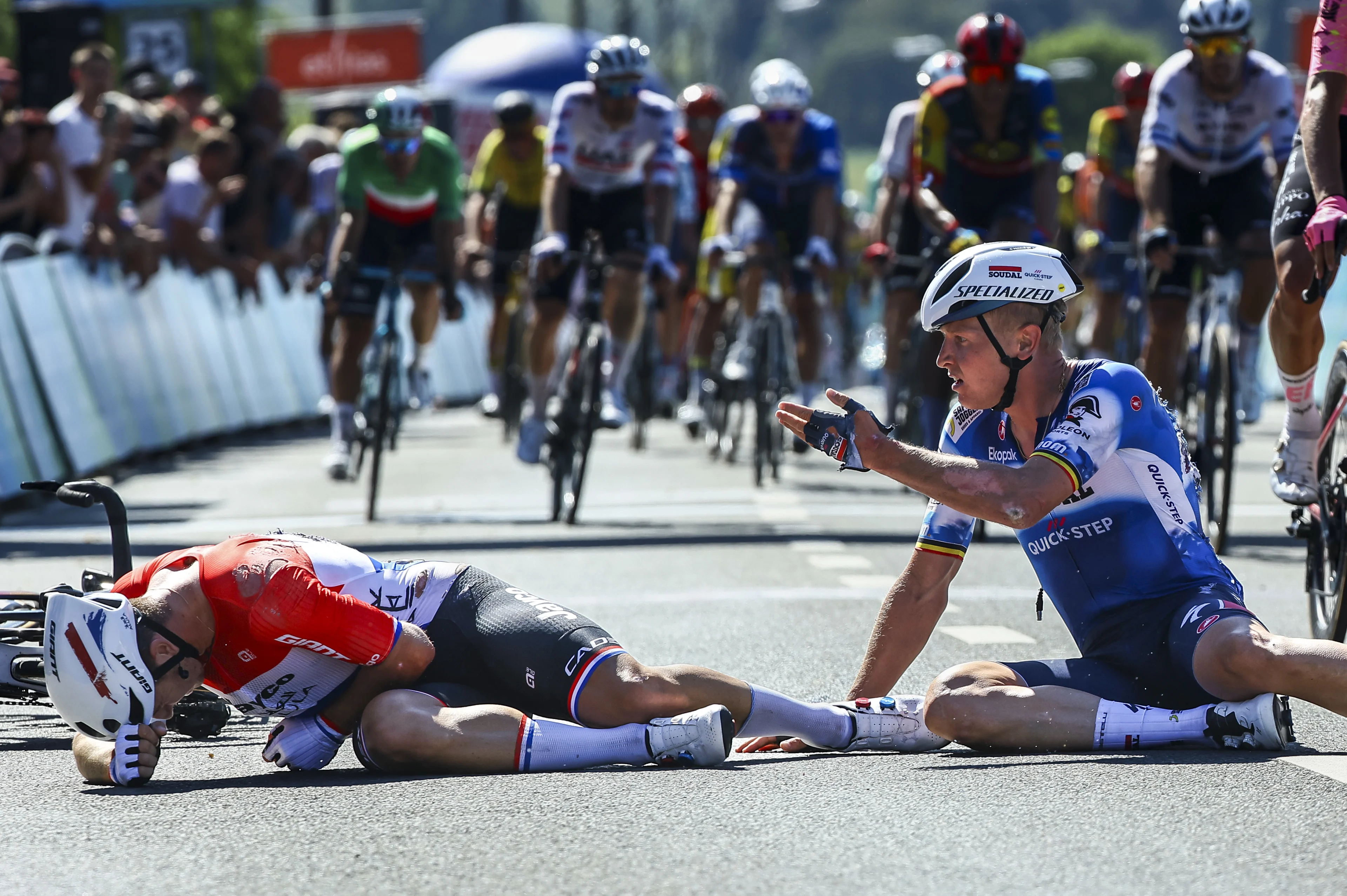 Dutch Dylan Groenewegen of Team Jayco Alula and Belgian Tim Merlier of Soudal Quick-Step crash after the sprint at the finish of the first stage of the 'Renewi Tour' multi-stage cycling race, from Riemst to Bilzen (163,6 km) on Wednesday 28 August 2024. The five-day race takes place in Belgium and the Netherlands. BELGA PHOTO DAVID PINTENS