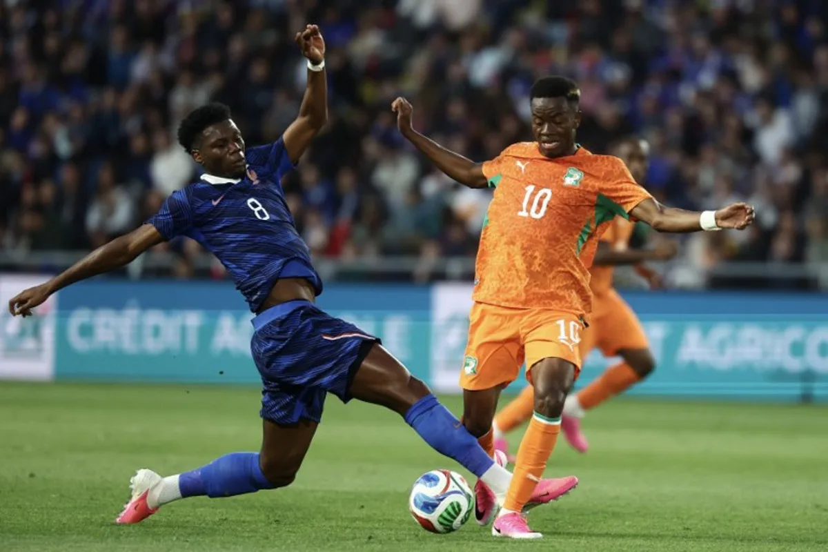 France's midfielder #08 Aurelien Tchouameni (L) fights for the ball with Ivory Coast's forward #10 Simon Adingra (R) during the international friendly football match between France and Ivory Coast ahead of the 2026 FIFA World Cup football tournament at the Stade de la Beaujoire in Nantes, western France, on June 4, 2026. FRANCK FIFE / AFP
