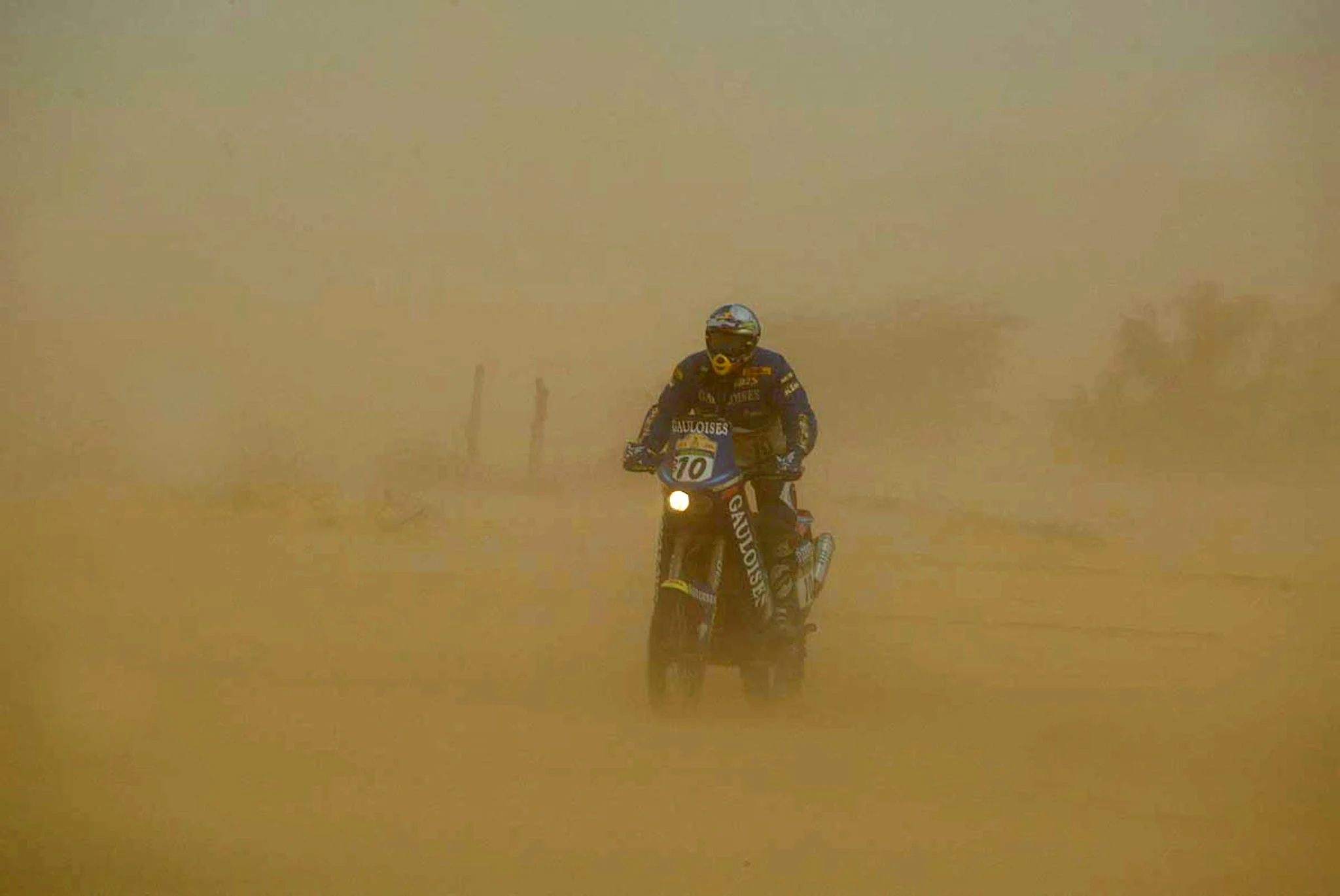 BRU112 - 20040108 - ATAR, MAURITANIA: Unidentified moto driver pictured through a sand storm during the 8th stage of the 26th Dakar rally raid, between Atar and Tidjikja in Mauritania, Thursday 08 January 2004. BELGA PHOTO WILLY WEYENS