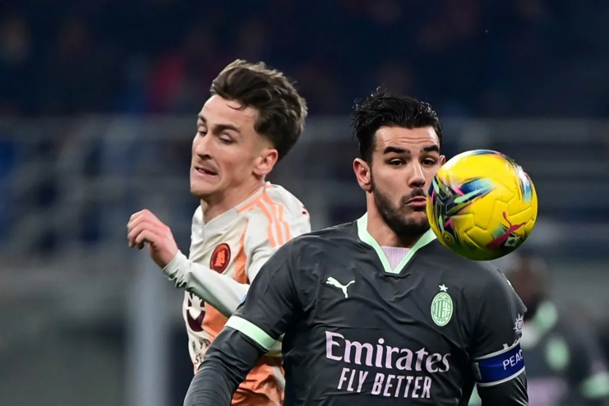 AC Milan's French defender #19 Theo Hernandez (R) fights for the ball with Roma's Belgian midfielder #56 Alexis Saelemaekers during the Italian Serie A football match between AC Milan and AS Roma at the San Siro Stadium in Milan, on December 29, 2024.  Piero CRUCIATTI / AFP