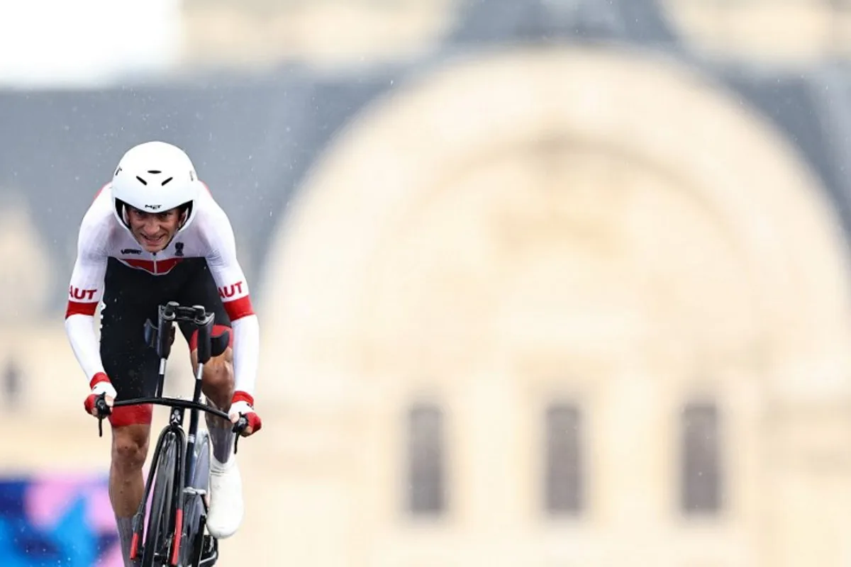 Austria's Felix Grossschartner cycles to cross the finish line of the men's road cycling individual time trial during the Paris 2024 Olympic Games in Paris, on July 27, 2024. Anne-Christine POUJOULAT / AFP