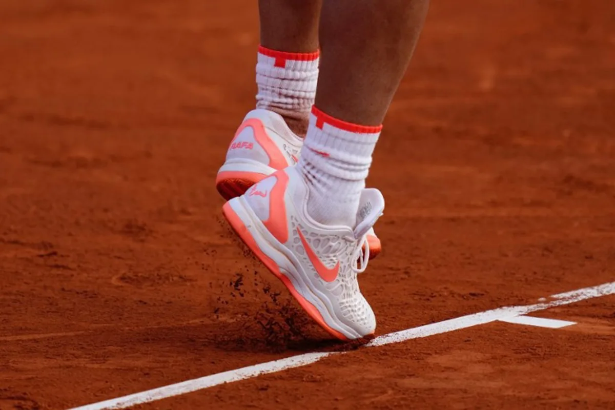Spain's Rafael Nadal serves the ball to Italy's Flavio Cobolli during the ATP Barcelona Open "Conde de Godo" tennis tournament singles match at the Real Club de Tenis in Barcelona, on April 16, 2024. PAU BARRENA / AFP