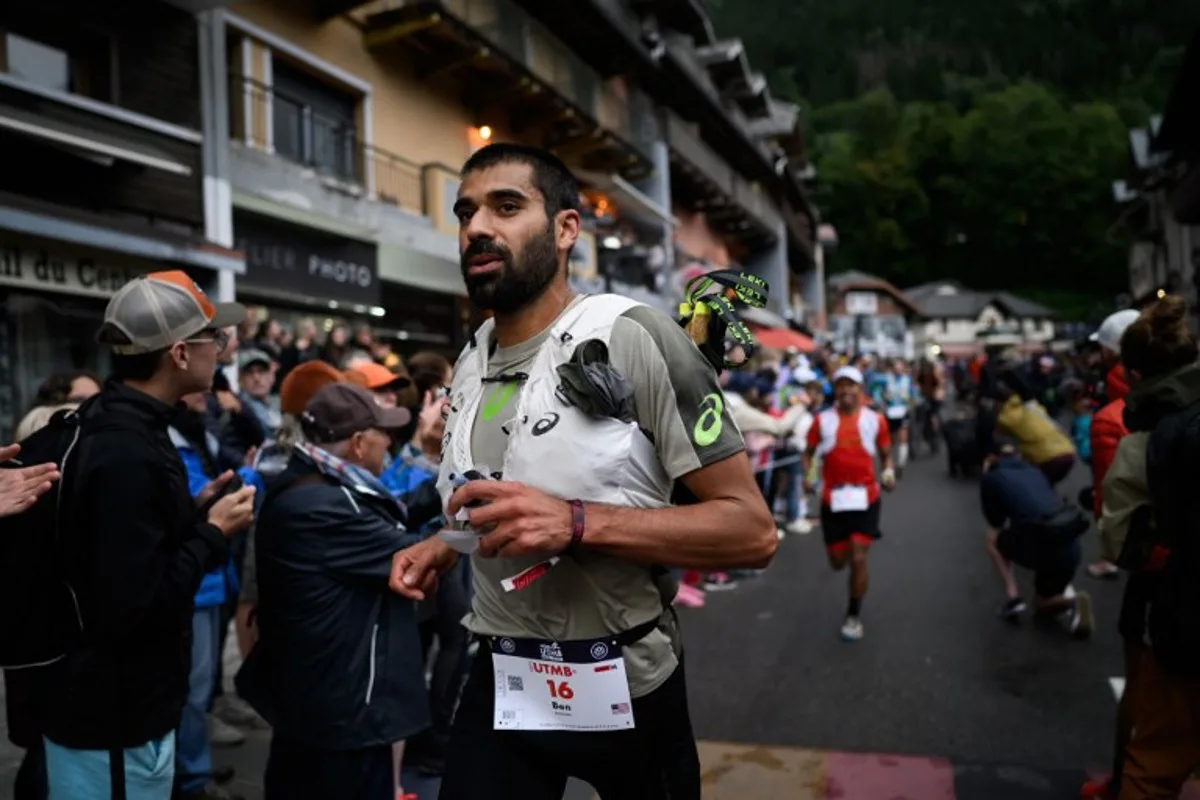 US trailer Ben Dhiman competes in the 22nd edition of the Ultra Trail du Mont Blanc (UTMB), a 174km trail race crossing France, Italy and Switzerland, in Chamonix, south-eastern France on August 29, 2025. JEFF PACHOUD / AFP