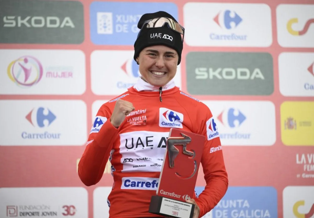 Winner of 2026 La Vuelta Femenina cycling tour of Spain, team UAE ADQ's Spanish rider Paula Blasi Cairol celebrates on the podium after the 7th stage, a 132.9 km race between Pola de Laviana and Alto de l'Angliru, on May 9, 2026. Miguel RIOPA / AFP