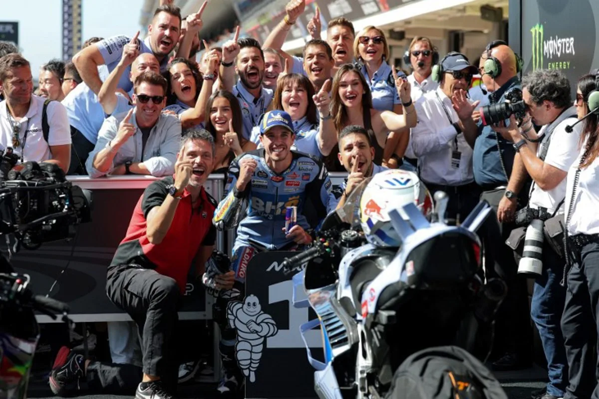 Pole position winner BK8 Gresini Racing MotoGP team's Spanish MotoGP rider Alex Marquez (C) celebrates with his team after the MotoGP qualifying session of the Moto Grand Prix de Catalunya at the Circuit de Catalunya on September 6, 2023 in Montmelo on the outskirts of Barcelona. Lluis GENE / AFP