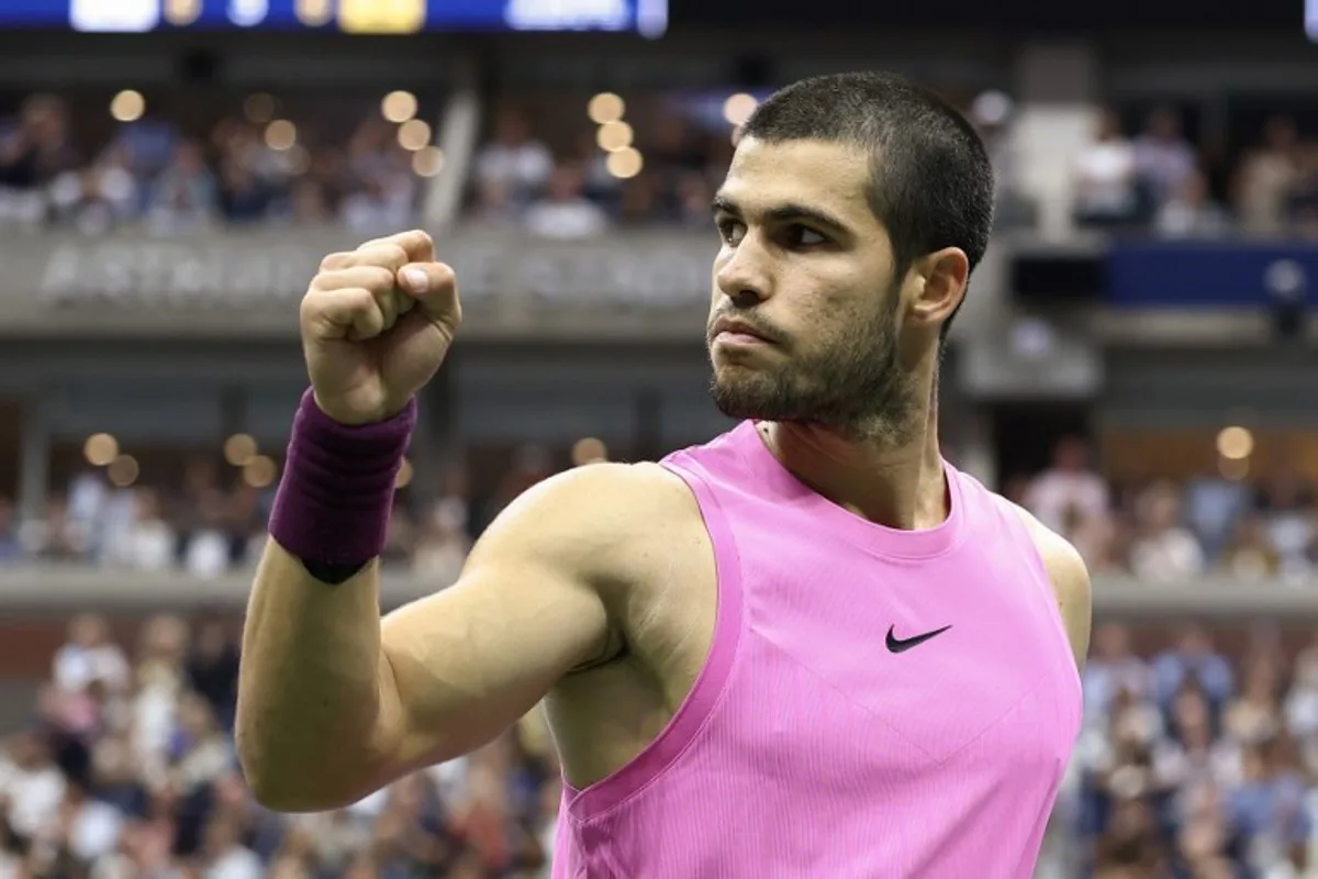 Spain's Carlos Alcaraz rects after a point against Italy's Jannik Sinner during the men's singles final tennis match on day fifteen of the US Open tennis tournament at the USTA Billie Jean King National Tennis Center in New York City on September 7, 2025. CHARLY TRIBALLEAU / AFP