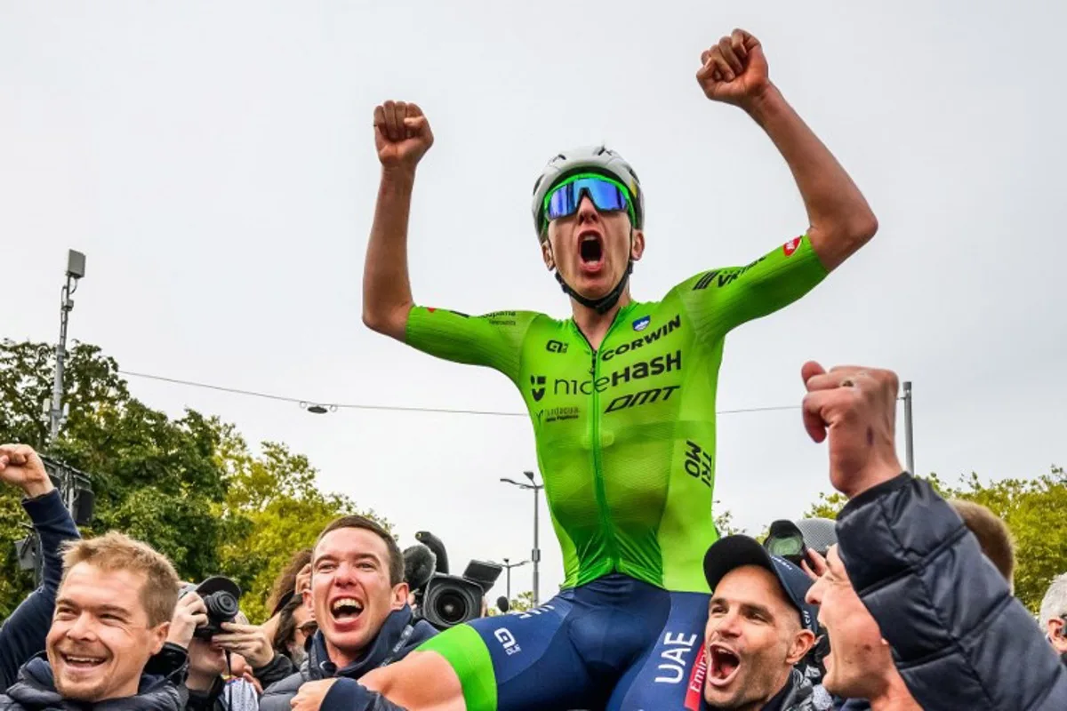 Slovenia's Tadej Pogacar celebrates with his team after winning the men's Elite Road Race cycling event during the UCI 2024 Road World Championships, in Zurich, on September 29, 2024.  Fabrice COFFRINI / AFP