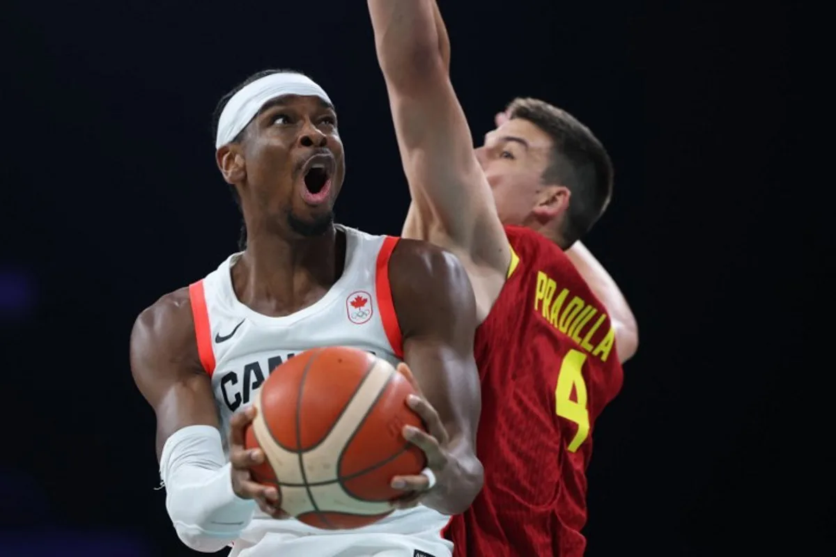 Canada's #02 Shai Gilgeous-Alexander (L) challenges Spain's #04 Jaime Pradilla in the men's preliminary round group A basketball match between Canada and Spain during the Paris 2024 Olympic Games at the Pierre-Mauroy stadium in Villeneuve-d'Ascq, northern France, on August 2, 2024. Thomas COEX / AFP