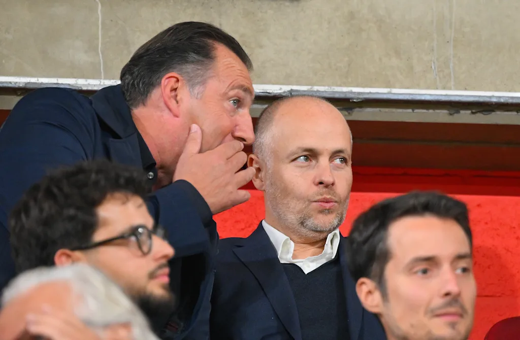 Standard's sport director Marc Wilmots, Ceo Standard's Giacomo Angelini and talk during a soccer match between Standard de Liege and KV Mechelen, Friday 12 September 2025 in Liege, on day 7 of the 2025-2026 'Jupiler Pro League' first division of the Belgian championship. BELGA PHOTO JOHN THYS