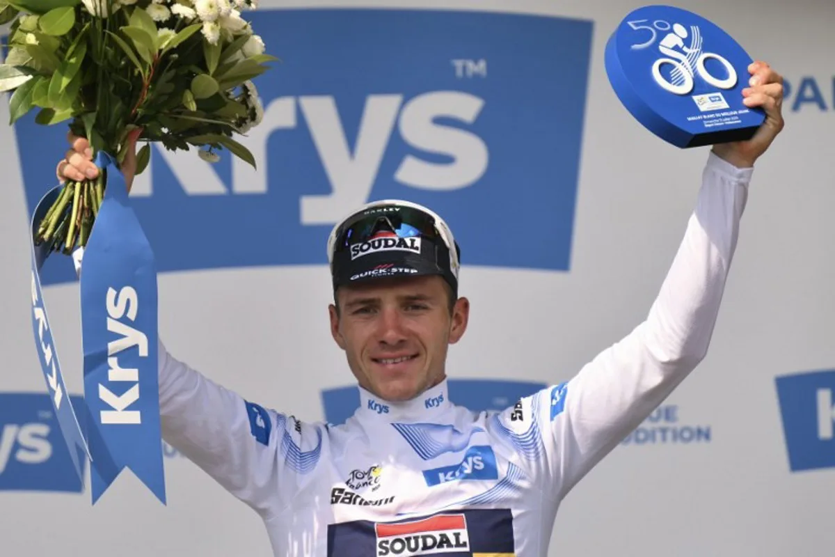 Soudal Quick-Step team's Belgian rider Remco Evenepoel celebrates on the podium with the best young rider's white jersey after the 9th stage of the 112th edition of the Tour de France cycling race, 174.1 km between Chinon and Chateauroux, central France, on July 13, 2025. Marco BERTORELLO / AFP