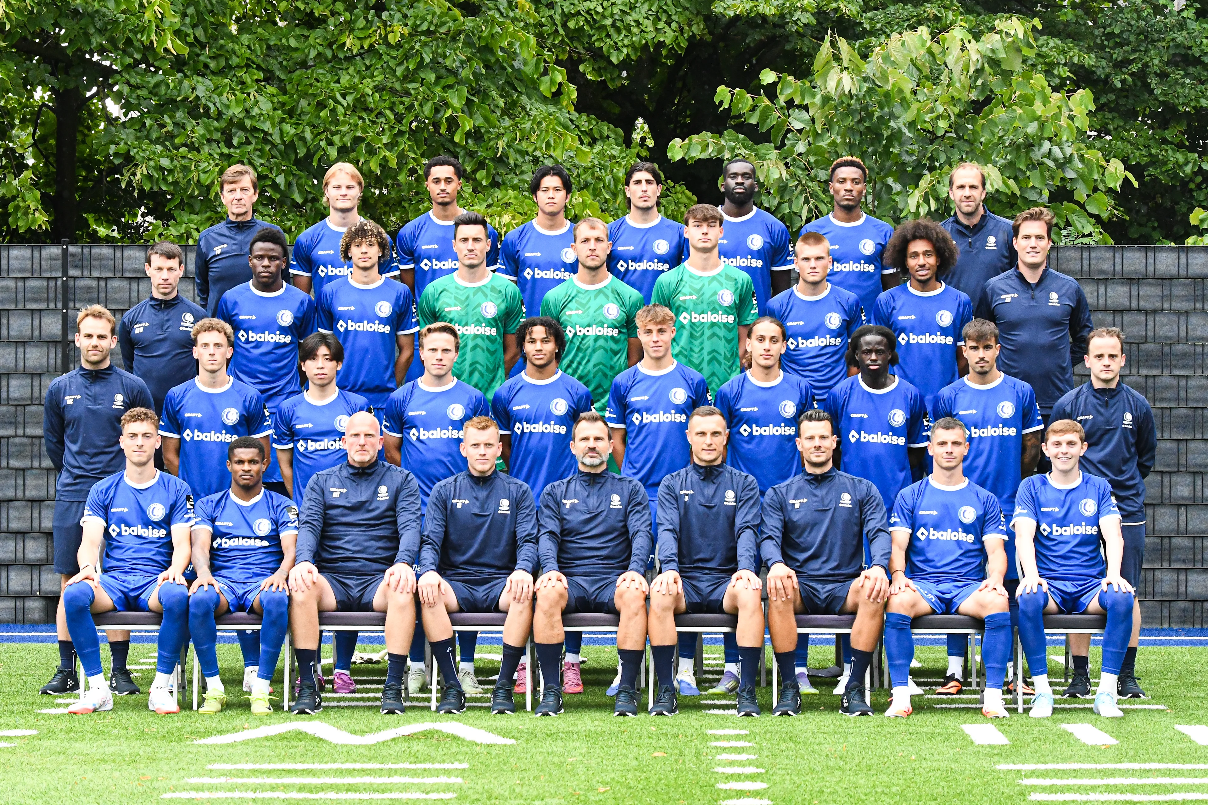 Row 4: Frank Wezenbeek, Andri Gudjohnsen, Aimé Omgba, Atsuki Ito, Omri Gandelman, Wilfried Kanga, Samuel Kotto, Matti Mortier Row 3: Bart De Winne, Hyllarion Goore, Franck Surdez, Tom Vandenberghe, Davy Roef, Bas Evers, Bram Lagae, Hugo Gambor, Stijn Matthys Row 2: Jens De Decker, Gilles De Meyer, Daisuke Yokota, Matisse Samoise, Momodou Sonko, Tibe De Vlieger, Mohammed El Adfaoui, Leonardo Lopes Da Silva, Tiago Araujo, Simon Bourgeois Row 1: Mathias Delorge, Helio Varela, Bart Van Tornhout, Nicolas Still, Ivan Leko, Timothy Derijck, Glenn Vanryckegem, Dante Vanzeir, Max Dean pose for a team picture at the 2025-2026 season photoshoot of Belgian soccer team KAA Gent, Wednesday 23 July 2025 in Gent. BELGA PHOTO JILL DELSAUX