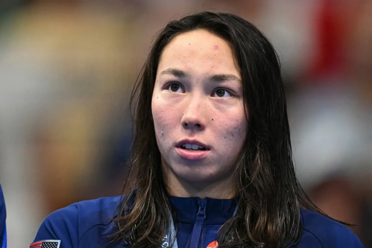Gold medallist US' Torri Huske stands on the podium after the final of the women's 100m butterfly swimming event during the Paris 2024 Olympic Games at the Paris La Defense Arena in Nanterre, west of Paris, on July 28, 2024. Manan VATSYAYANA / AFP
