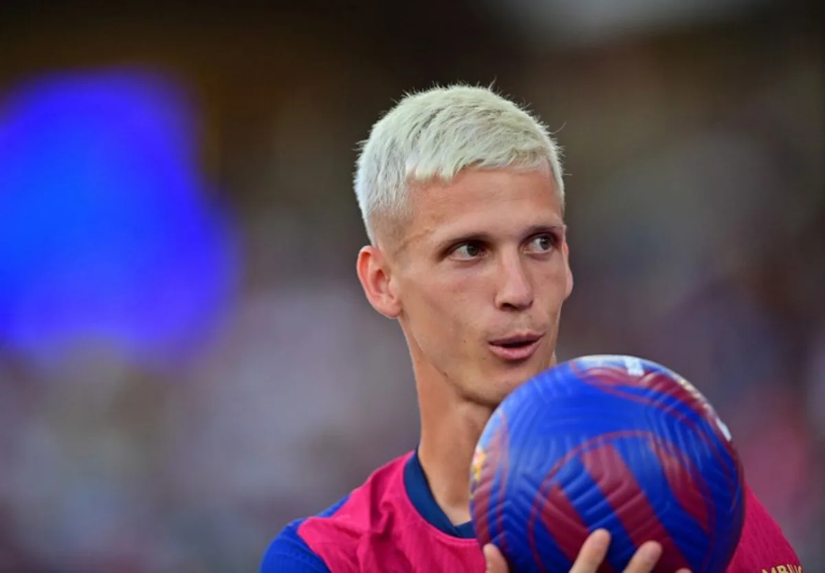 Barcelona's Spanish midfielder #20 Dani Olmo looks on during his presentation prior the 59th Joan Gamper Trophy football match between FC Barcelona and AS Monaco at the Estadi Olimpic Lluis Companys in Barcelona on August 12, 2024.  MANAURE QUINTERO / AFP