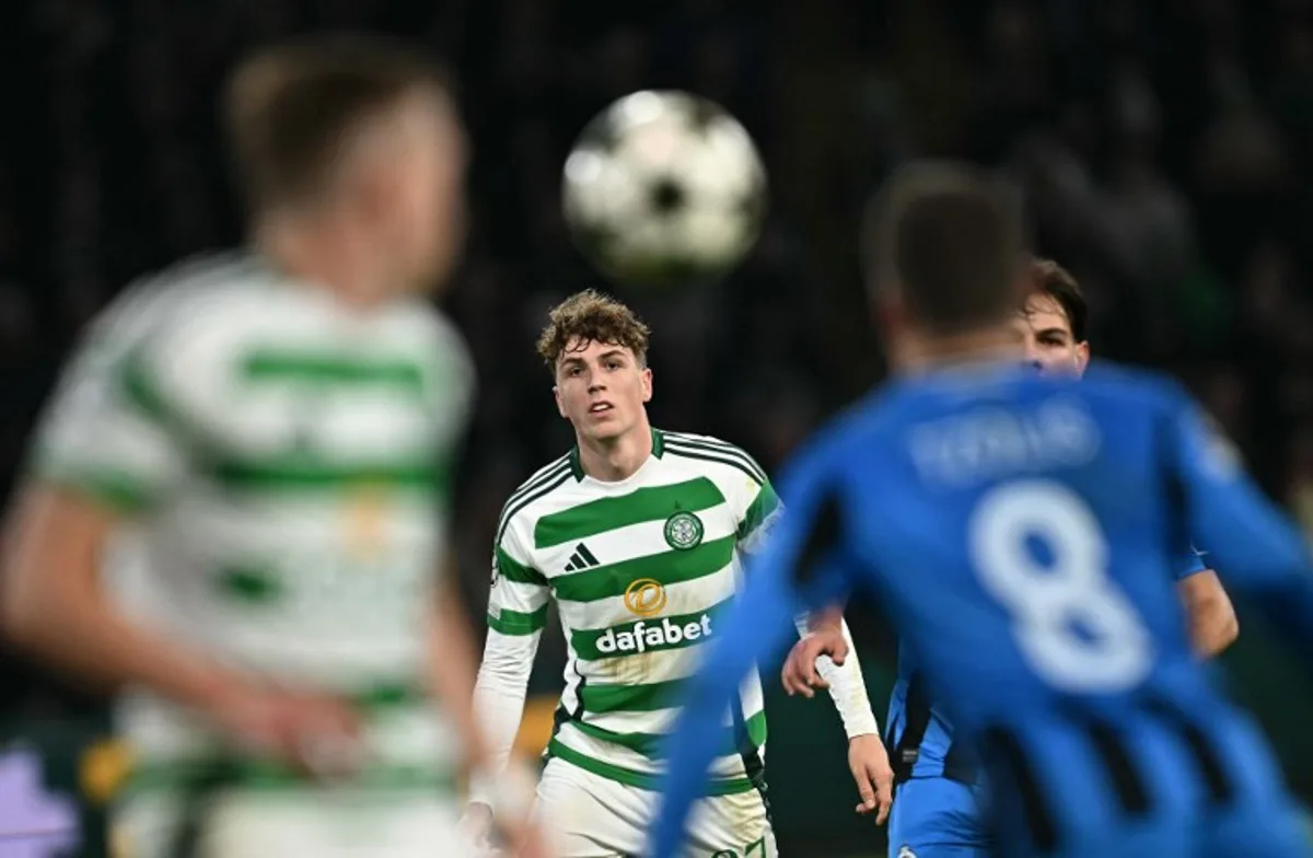 Celtic's Belgian midfielder #27 Arne Engels (C) watches his crossed ball during the UEFA Champions League football match between Celtic and Club Brugge at Celtic Park stadium in Glasgow, Scotland on November 27, 2024.   Paul ELLIS / AFP