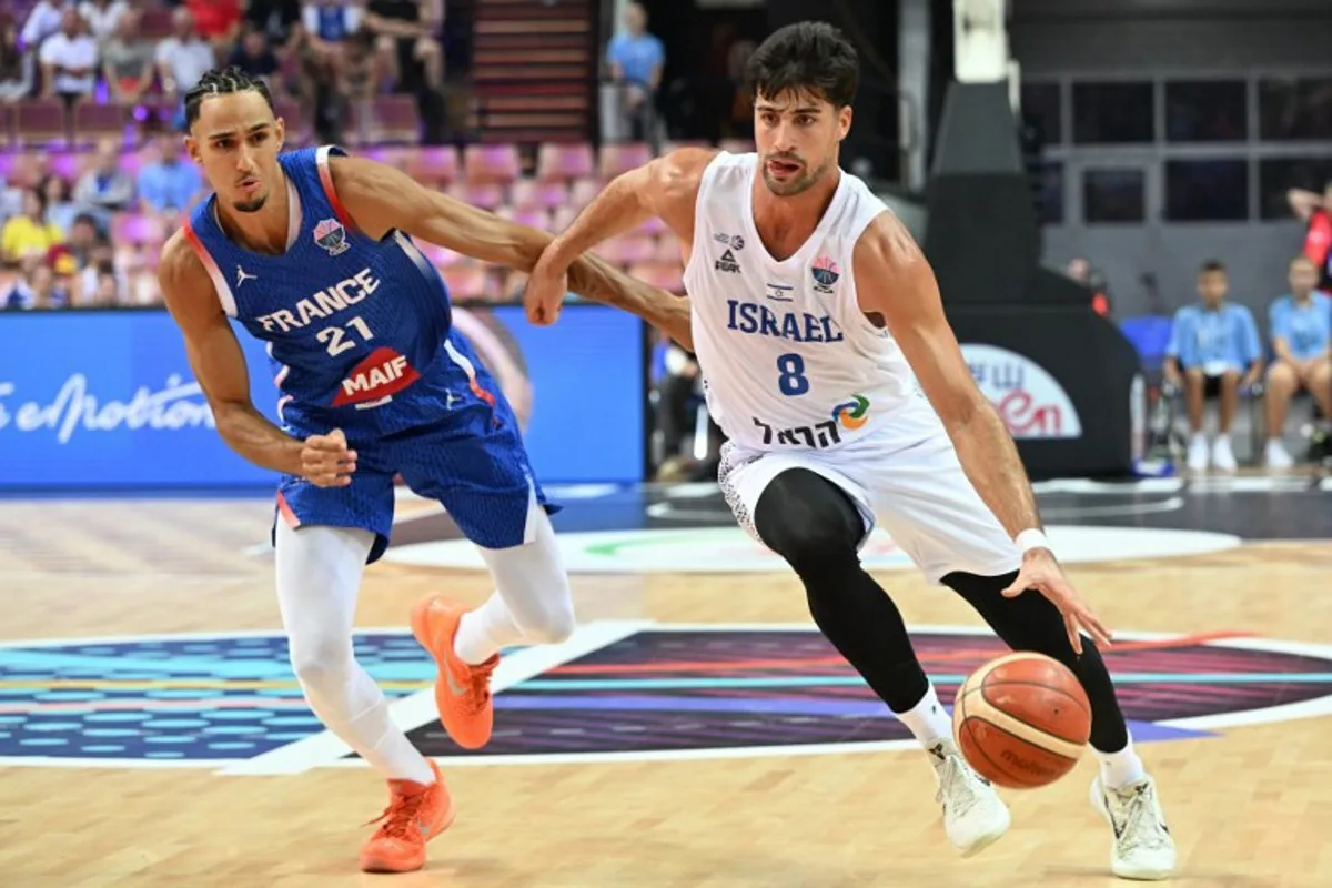 France's small forward #21 Zaccharie Risacher (L) and Israel's forward #08 Deni Avdija (R) vie during the FIBA EuroBasket 2025 Group D basketball match between Israel and France at the Spodek Arena in Katowice, Poland on August 31, 2025. Sergei GAPON / AFP
