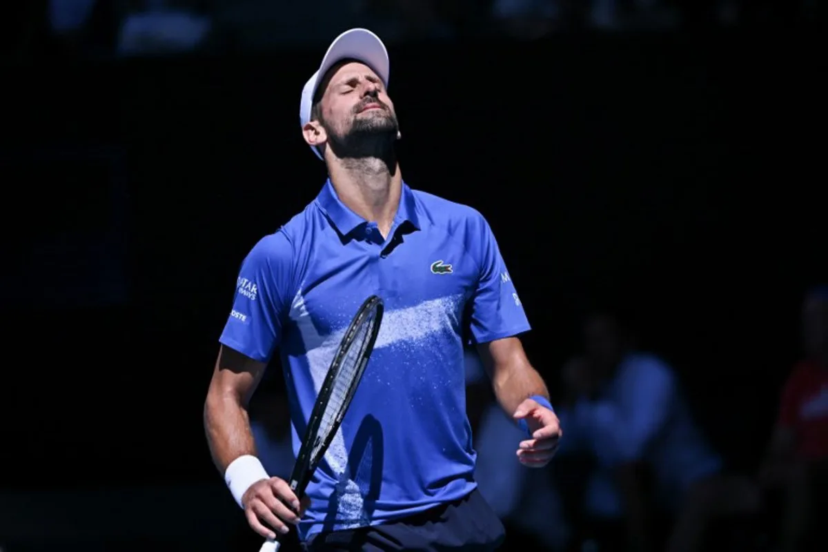 Serbia's Novak Djokovic reacts on a point against Germany's Alexander Zverev during their men's singles semi-final match on day thirteen of the Australian Open tennis tournament in Melbourne on January 24, 2025.  WILLIAM WEST / AFP