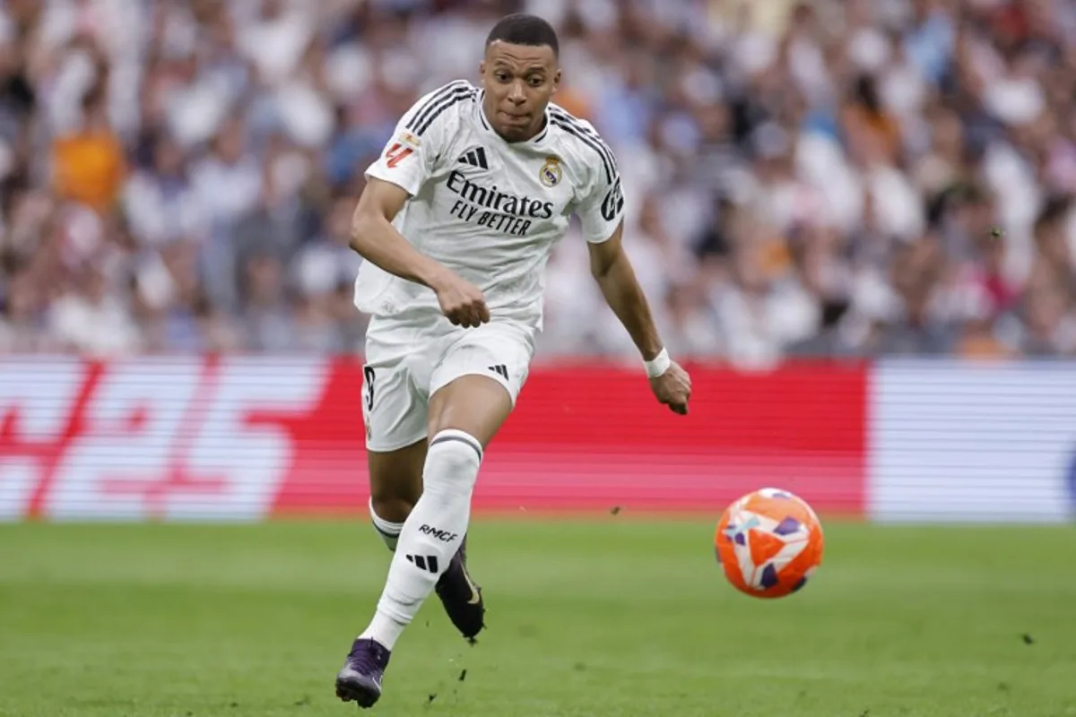 Real Madrid's French forward #09 Kylian Mbappe runs for the ball during the Spanish league football match between Real Madrid CF and Real Sociedad at Santiago Bernabeu Stadium in Madrid on May 24, 2025. OSCAR DEL POZO / AFP