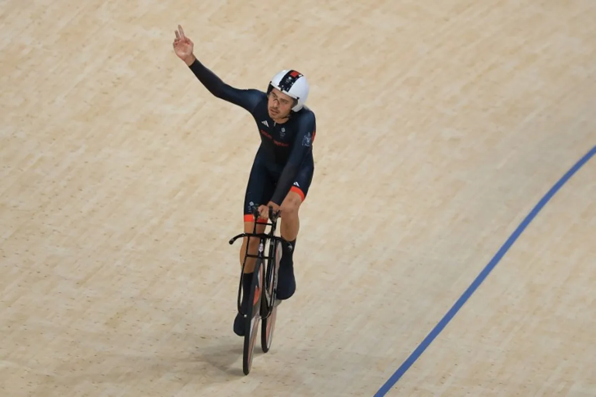 Britain's Charlie Tanfield reacts after a men's track cycling team pursuit first round of the Paris 2024 Olympic Games at the Saint-Quentin-en-Yvelines National Velodrome in Montigny-le-Bretonneux, south-west of Paris, on August 6, 2024. Emmanuel DUNAND / AFP