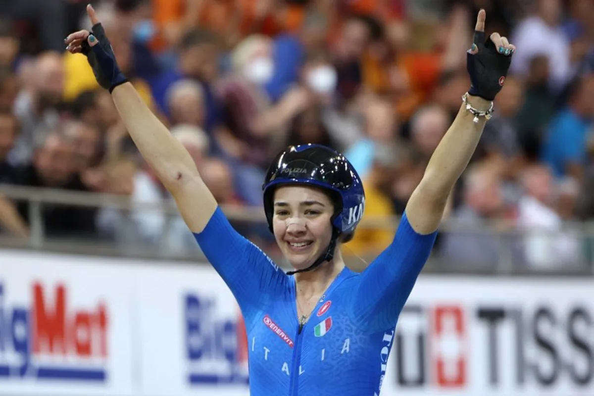 Italy's Martina Fidanza celebrates across the finish line after winning the Women's 10 km Scratch Race final during the UCI Track Cycling World Championships at the Velodrome of Saint-Quentin-en-Yvelines, southwest of Paris, on October 12, 2022. Thomas SAMSON / AFP