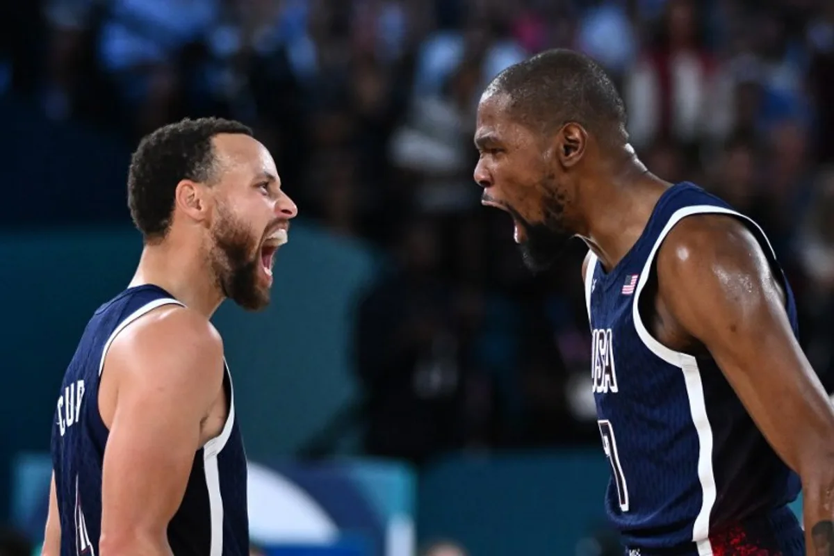 USA's #04 Stephen Curry (L) and USA's #07 Kevin Durant celebrates after scoring in the men's Gold Medal basketball match between France and USA during the Paris 2024 Olympic Games at the Bercy  Arena in Paris on August 10, 2024.  Aris MESSINIS / AFP