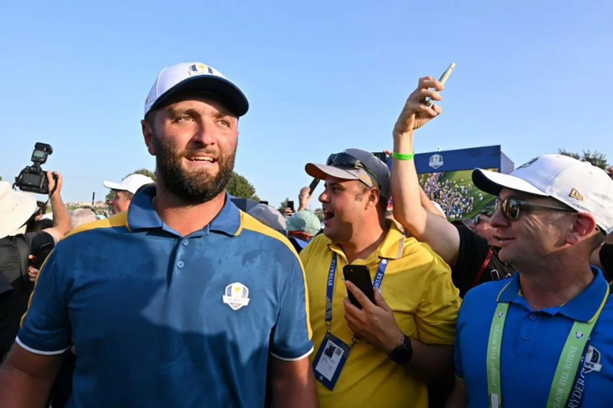 Europe's Spanish golfer, Jon Rahm walks through the crowds as European players celebrate their victory on the final day of play in the 44th Ryder Cup at the Marco Simone Golf and Country Club in Rome on October 1, 2023. Alberto PIZZOLI / AFP