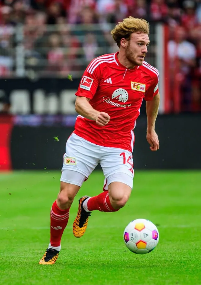 Union Berlin's Belgian forward #14 Yorbe Vertessen runs with the ball during the German first division Bundesliga football match between 1 FC Union Berlin and SC Freiburg in Berlin, Germany on May 18, 2024. Union Berlin secured Bundesliga play next season after defeating Freiburg 2-1. John MACDOUGALL / AFP