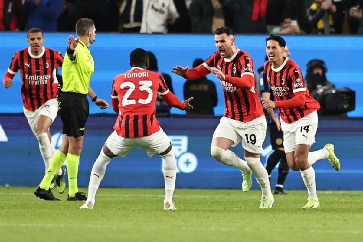 AC Milan's French defender #19 Theo Hernandez celebrates with AC Milan's English defender #23 Fikayo Tomori after scoring his team's first goal during the Italian Super Cup final football match between Inter Milan and AC Milan at the Al-Awwal Park in Riyadh on January 6, 2025.  FADEL SENNA / AFP