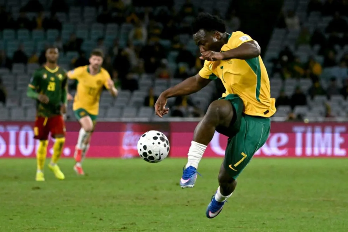 Australia's Nestory Irankunda kicks the ball during the international friendly football match between Australia and Cameroon at Stadium Australia in Sydney on March 27, 2026. SAEED KHAN / AFP