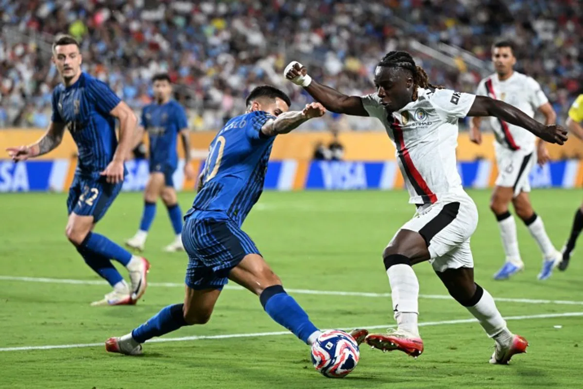 Al Hilal's Portuguese defender #20 Joao Cancelo and Manchester City's Belgian midfielder #11 Jeremy Doku fight for the ball during the FIFA Club World Cup 2025 round of 16 football match between England's Manchester City and Saudi's Al-Hilal at the Camping World stadium in Orlando on June 30, 2025. PATRICIA DE MELO MOREIRA / AFP