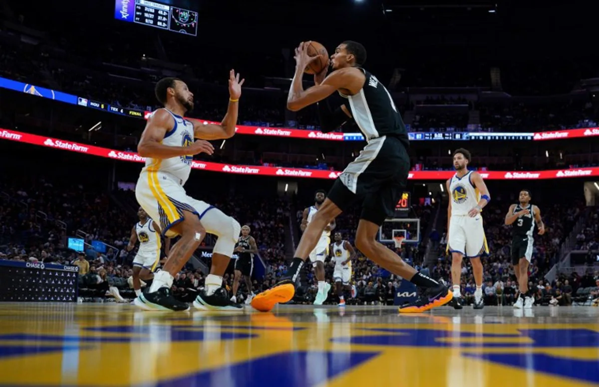 San Antonio Spurs' French forward-center #01 Victor Wembanyama drives towards the basket as Golden State Warriors' US guard #30 Stephen Curry defends during the NBA preseason game between the San Antonio Spurs and Golden State Warriors at Chase Center in San Francisco, California on October 20, 2023.   Loren Elliott / AFP