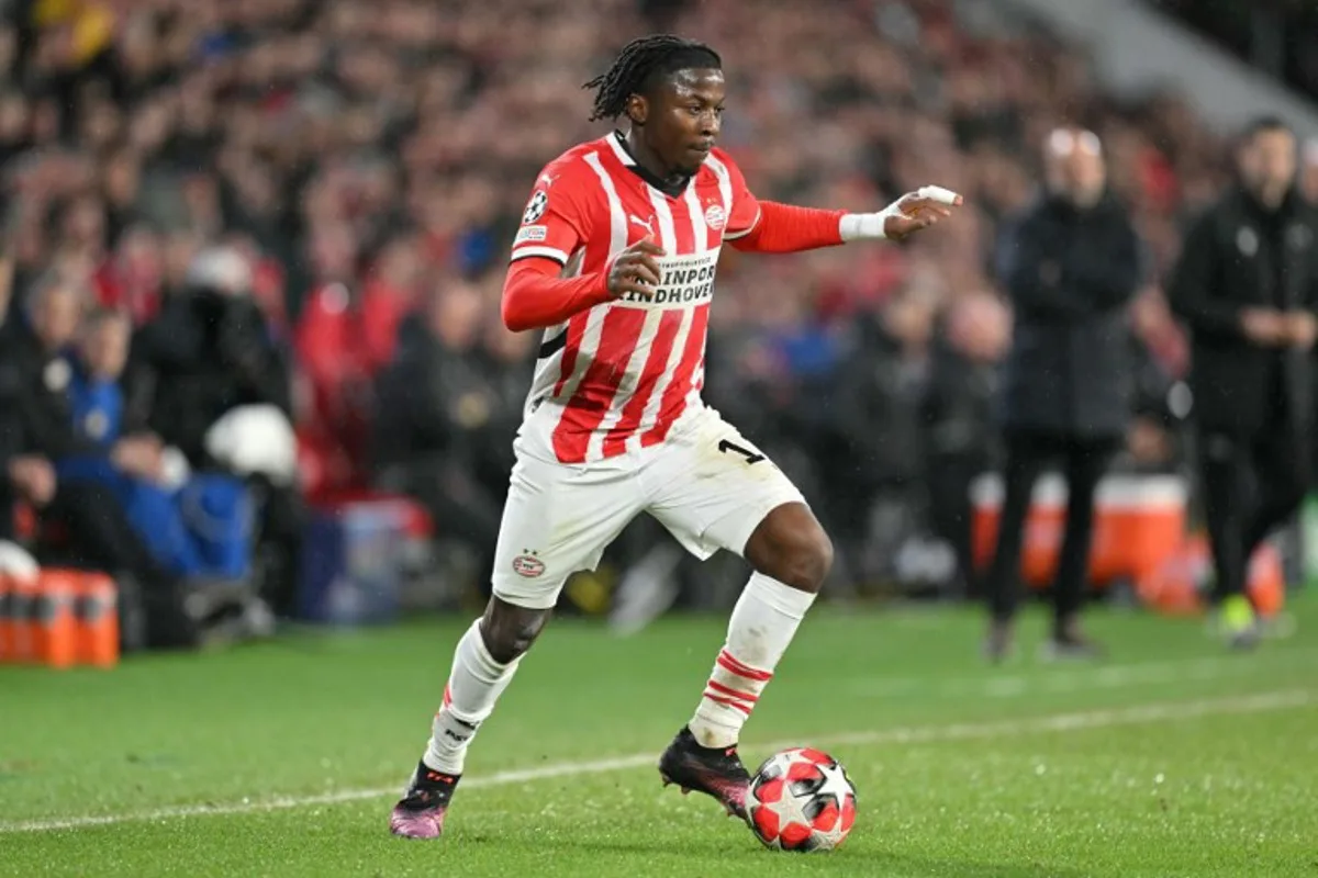 PSV Eindhoven's Belgian forward #11 Johan Bakayoko runs with the ball during the UEFA Champions League, league phase day 8, football match between PSV Eindhoven (NED) and Liverpool FC (ENG) at the the Philips Stadion, in Eindhoven, on January 29, 2025.  NICOLAS TUCAT / AFP